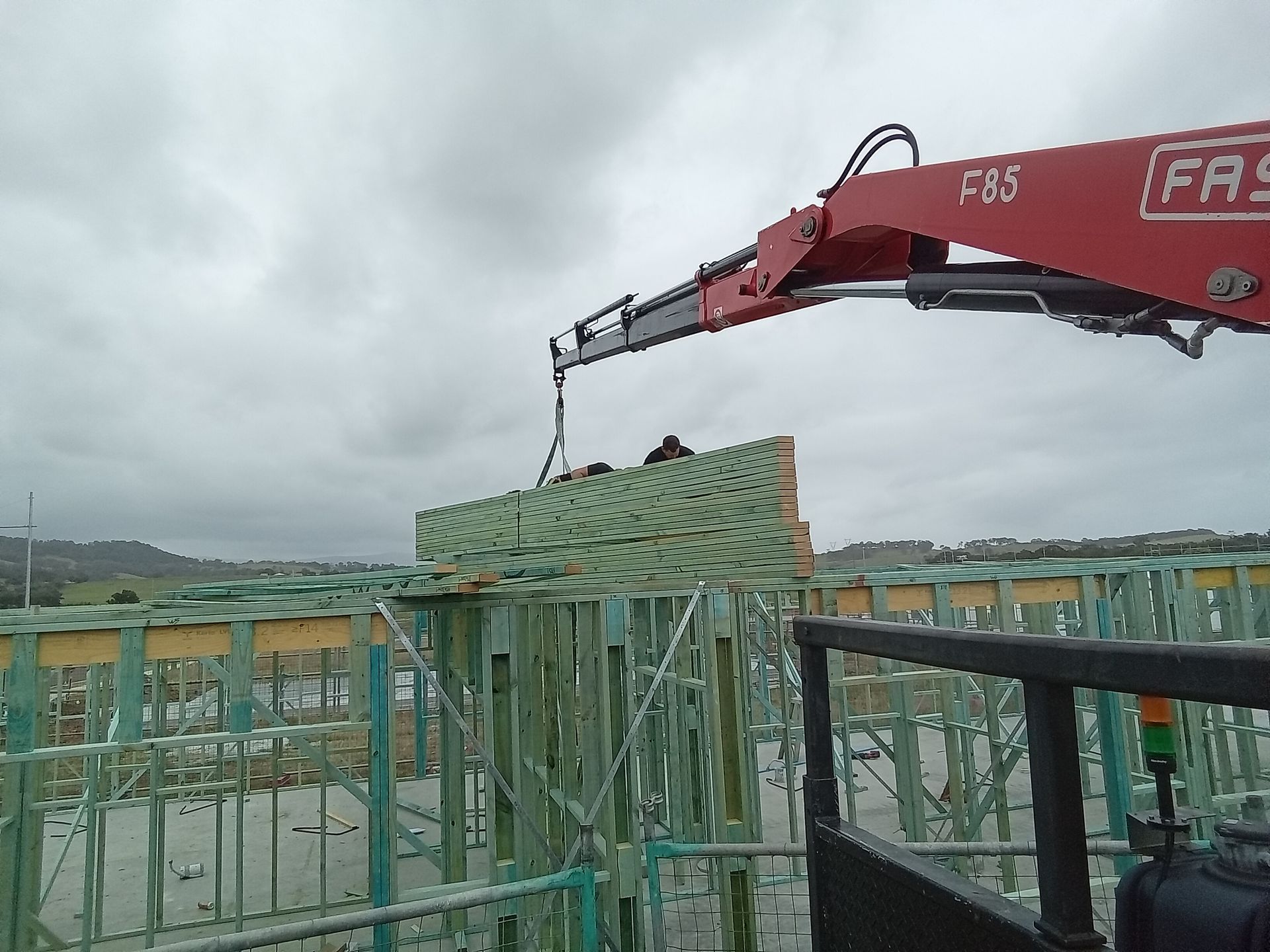 Timber roof trusses lifted into place at Calderwood construction site