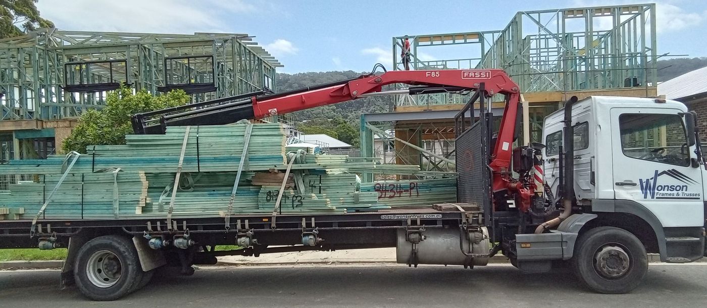 Timber wall frames delivered by Wonson truck to residential construction site