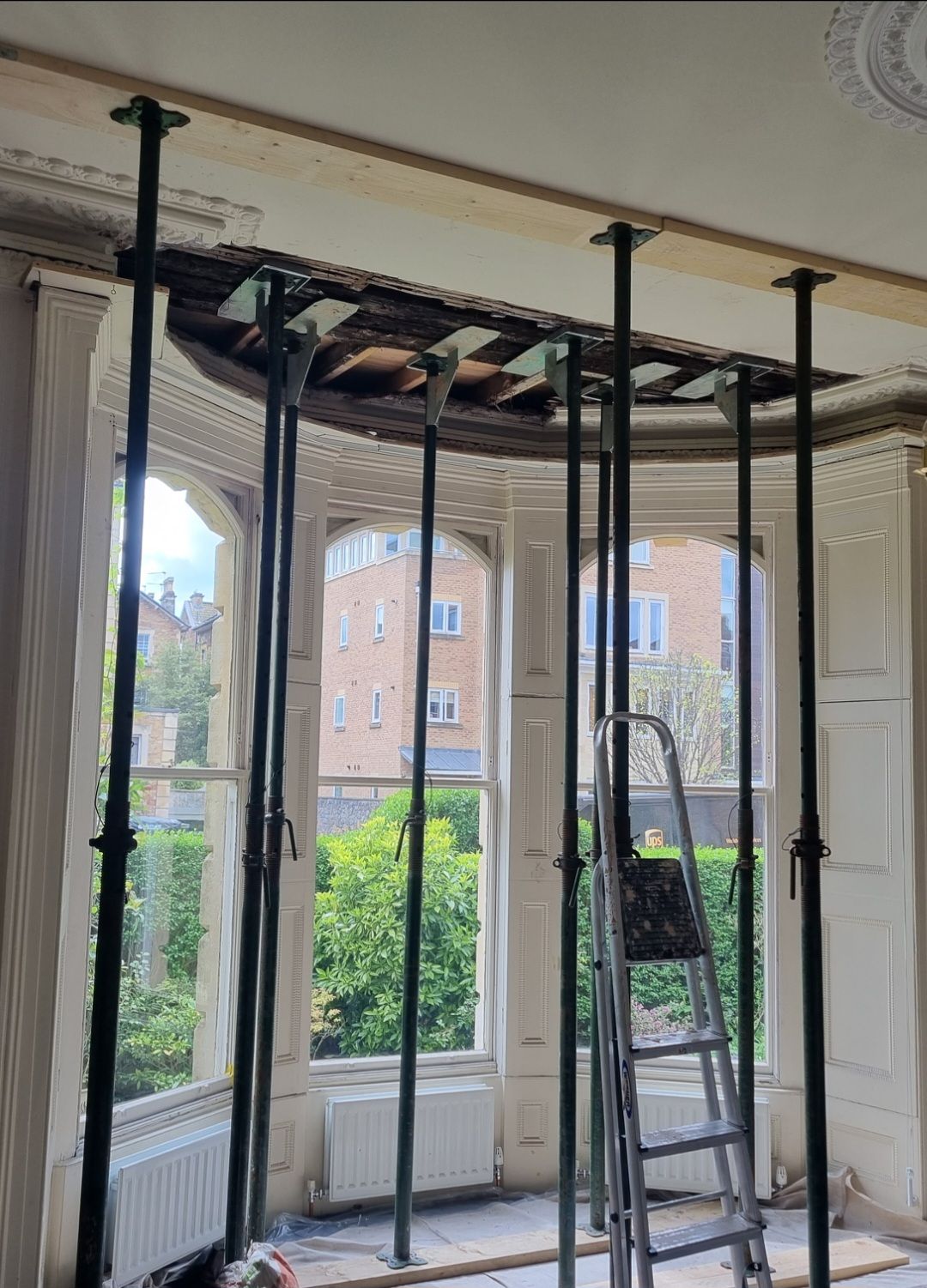 Structural repair to bay window replacing timber lintels with steel RSJ's. Ceiling propped and strong boys aka acro prop blades used for support designed by structural engineer.