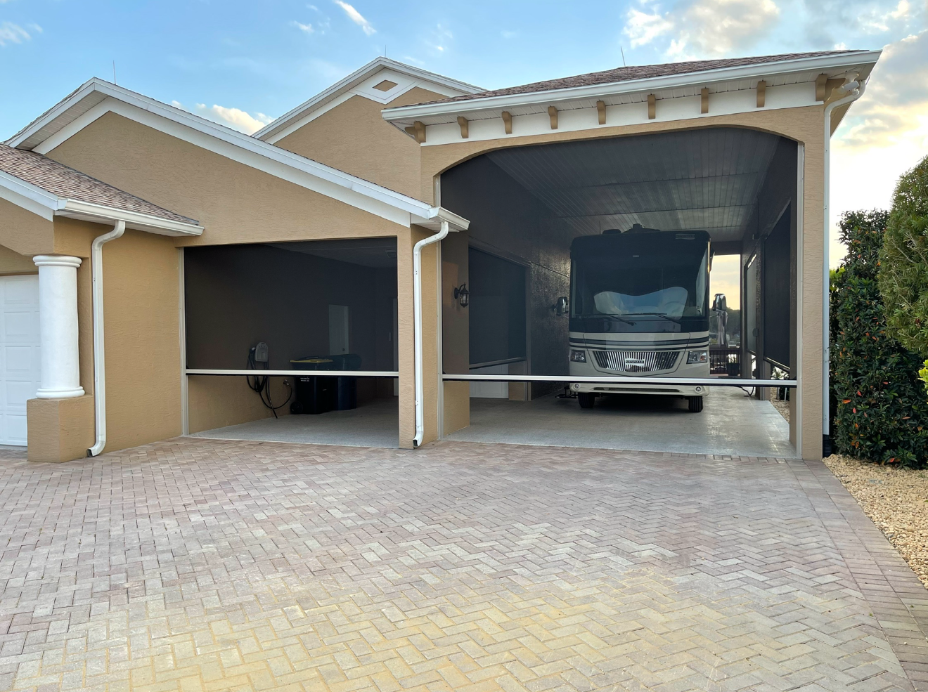 SunPro motorized exterior screen – patio – Palm Springs
A truck is parked in a garage in front of a house.