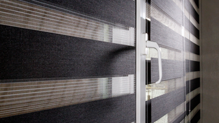 A close up of a window with blinds on it.
