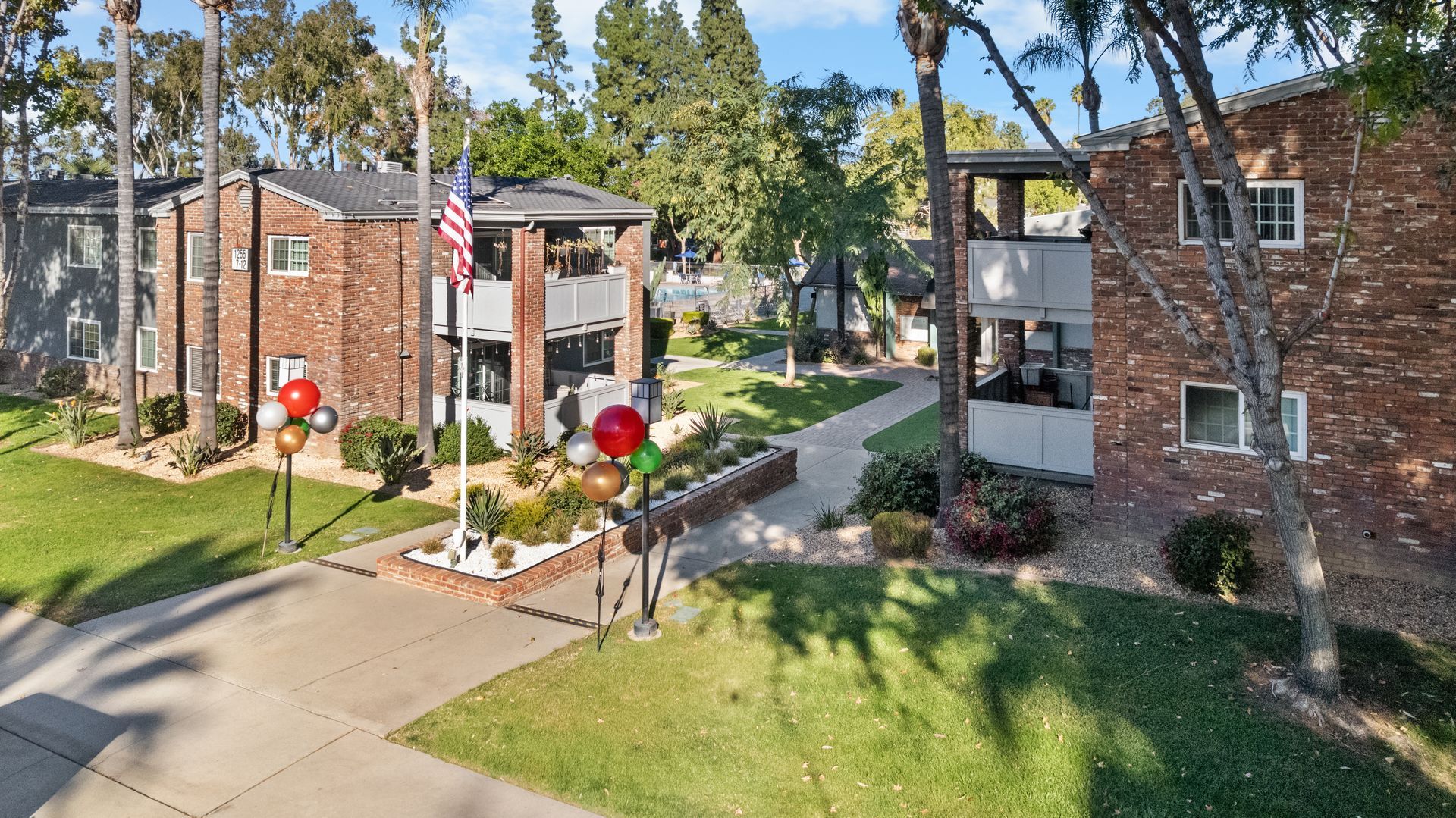 brick apartment walls with flag pole and balloons