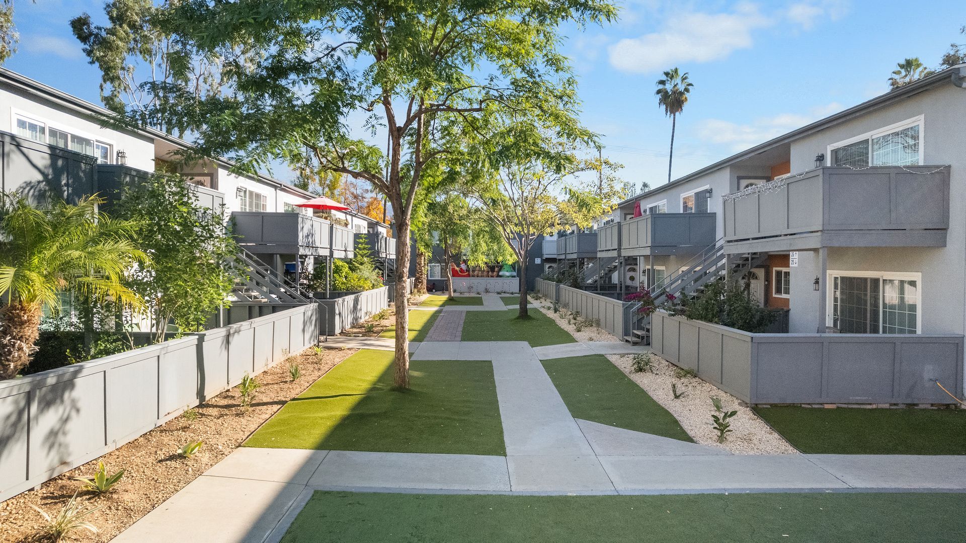 paved paths through grass and exterior apartments