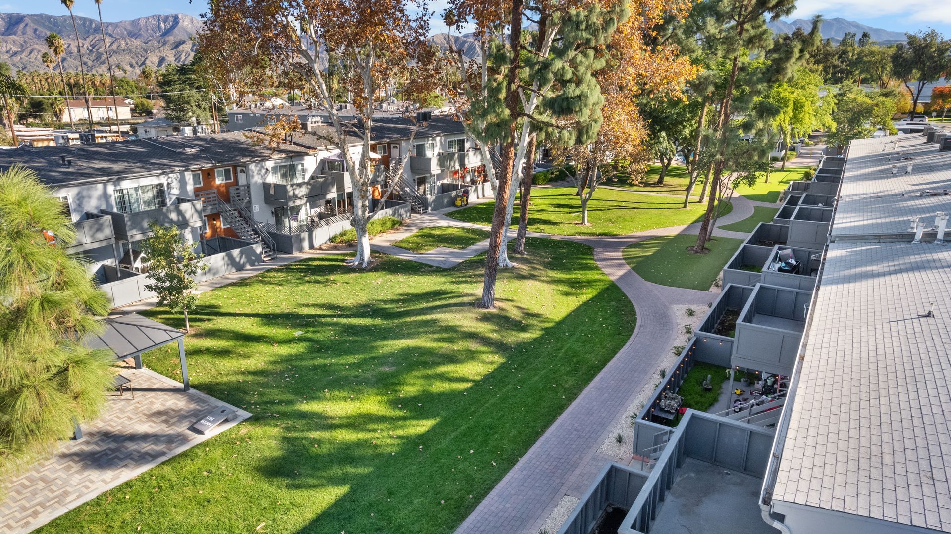 grass and trees with apartment exteriors