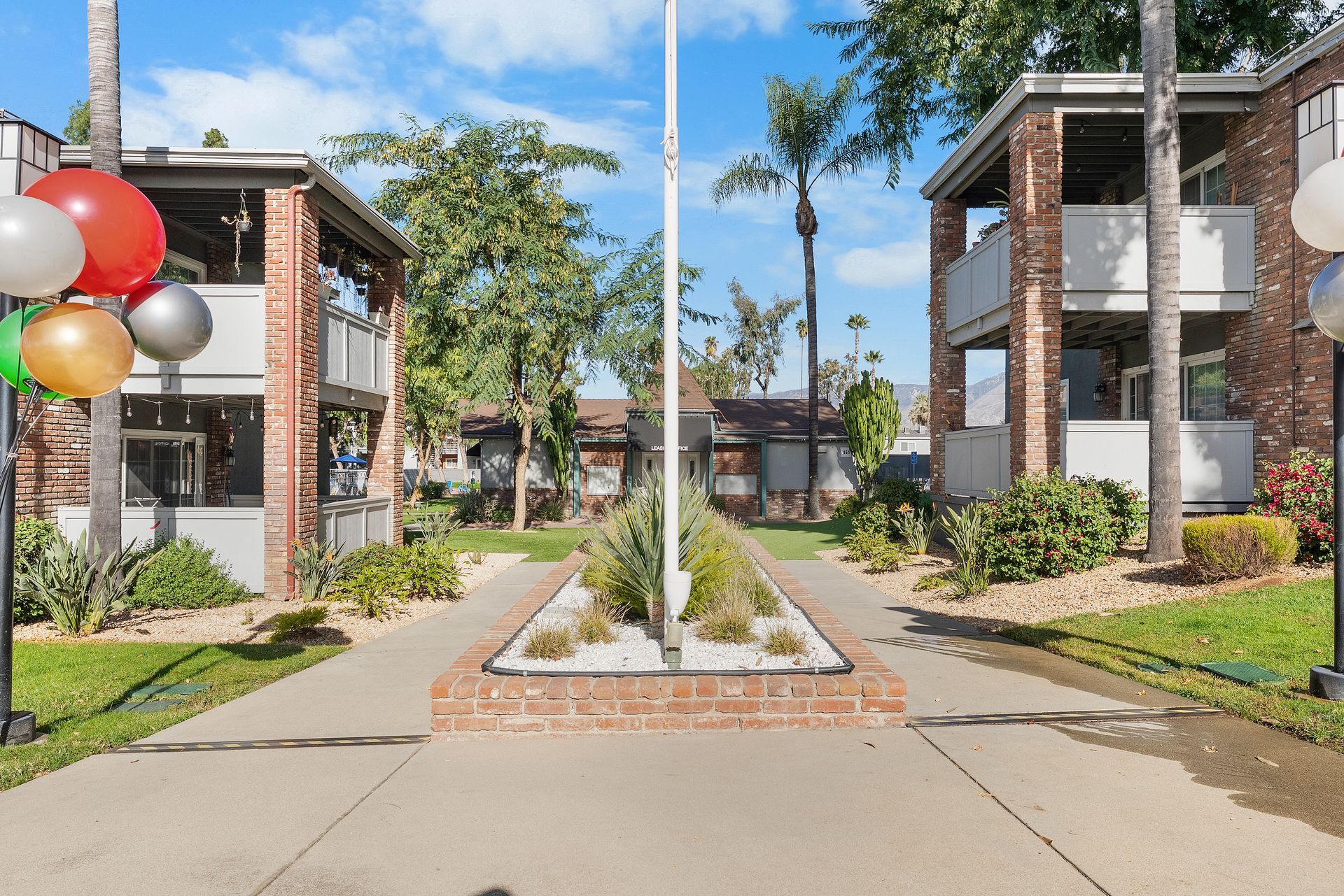 flag pole and paved paths through apartment exterior