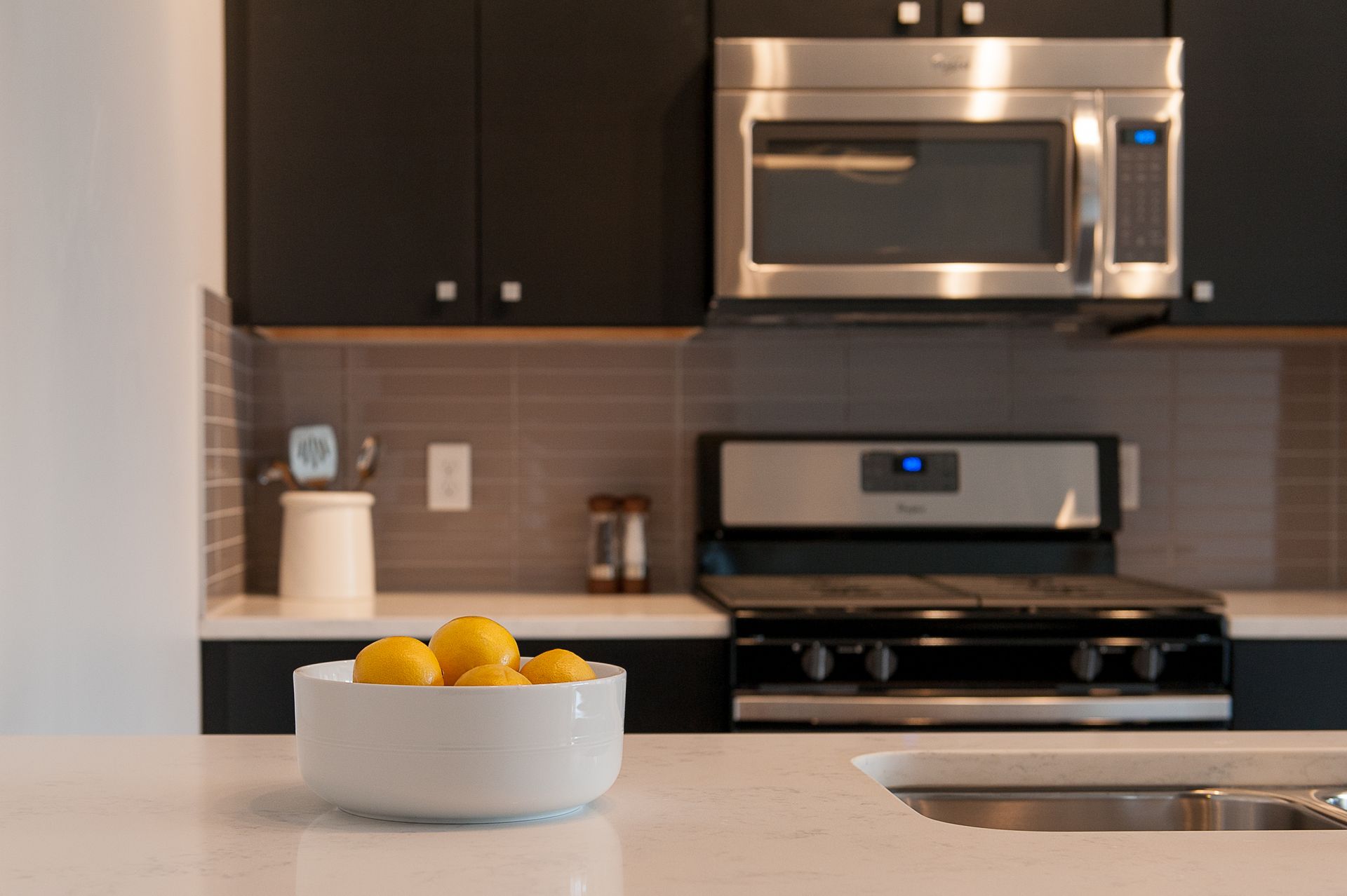 A kitchen with a bowl of lemons on the counter