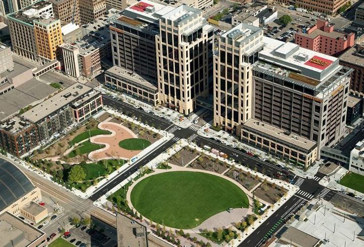 An aerial view of a city with a park in the middle.