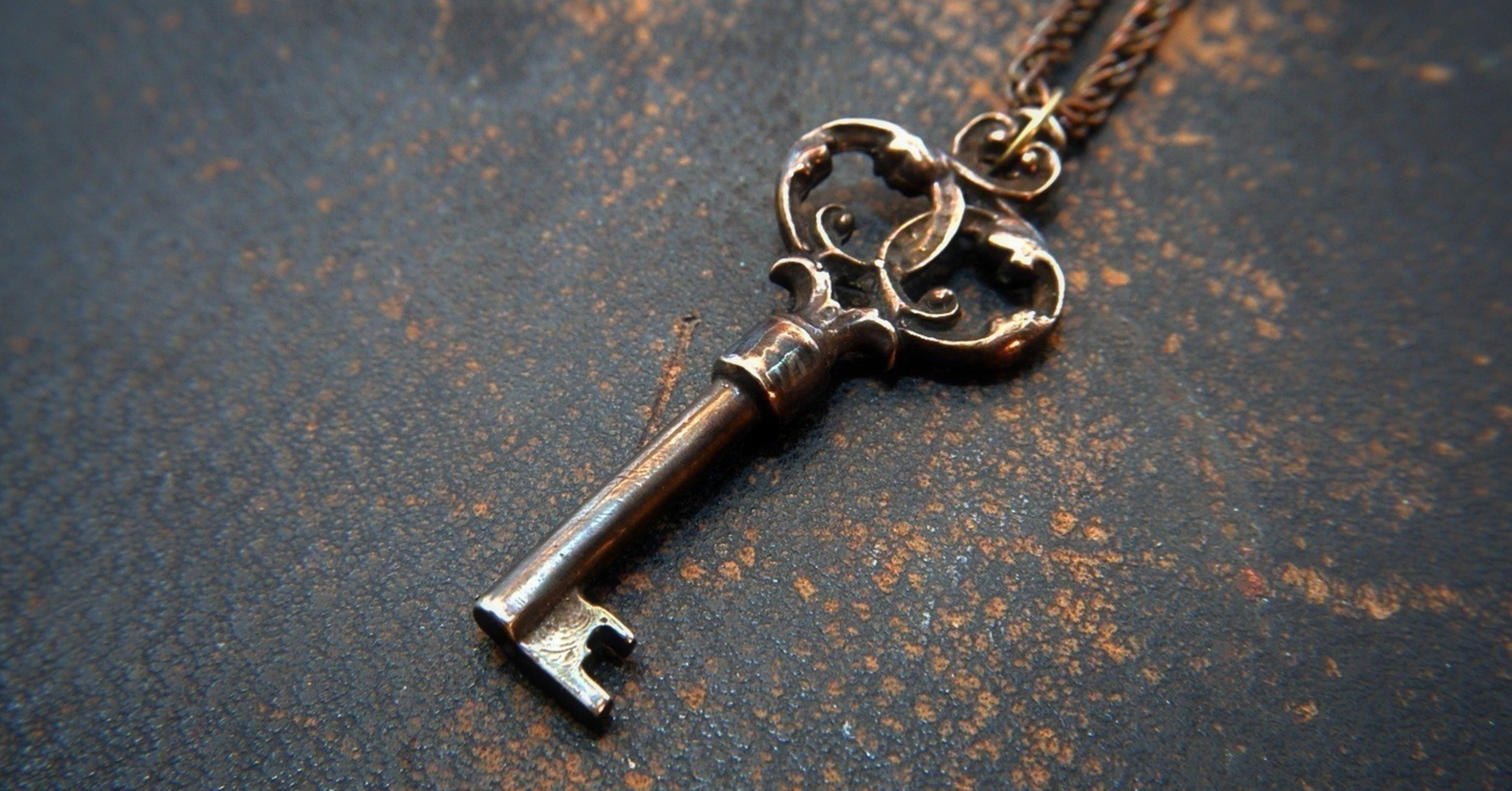 A close up of a key on a chain on a table.
