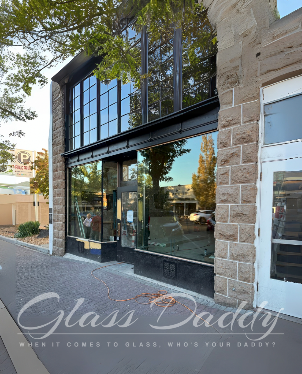 A building with a sign that says glass daddy on it