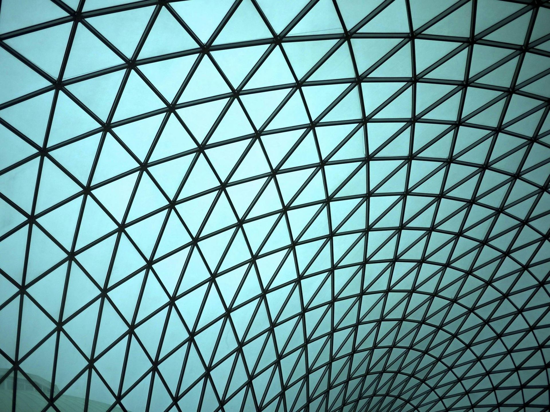Looking up at the ceiling of a building with a blue sky in the background