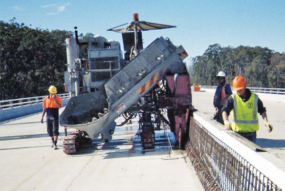 A group of construction workers are working on a bridge