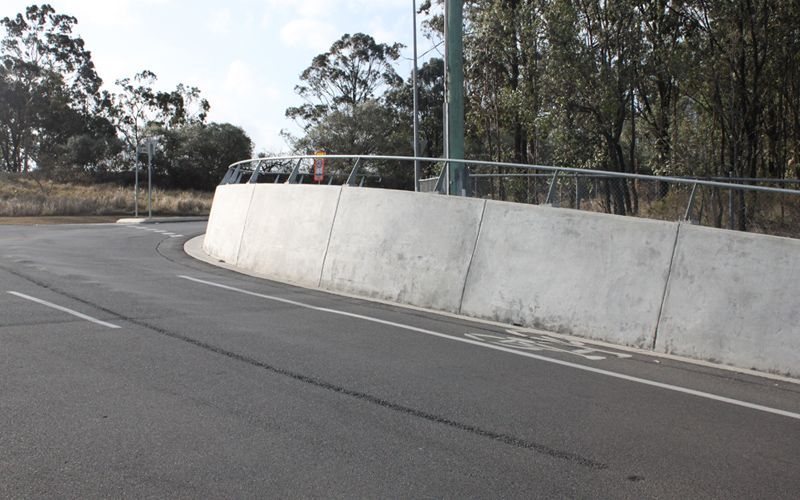 A road with a concrete barrier on the side of it