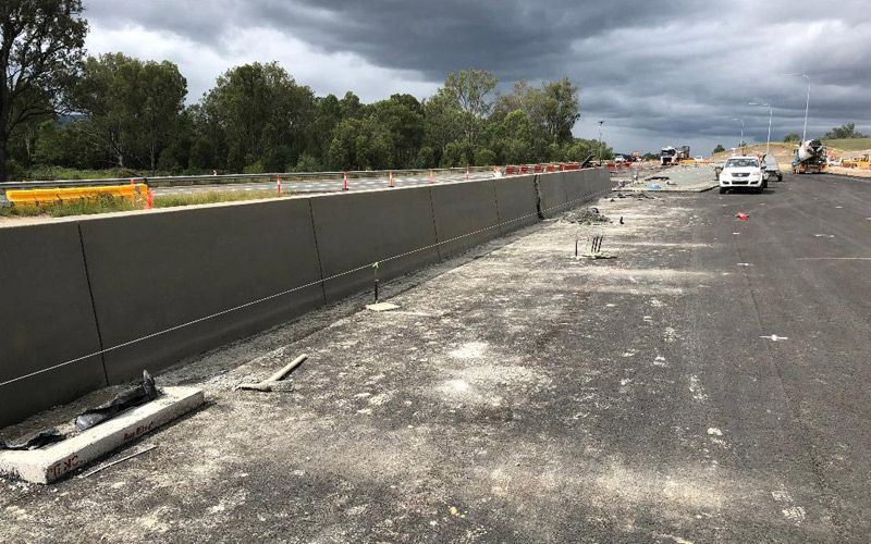 A car is parked on the side of a road under construction.