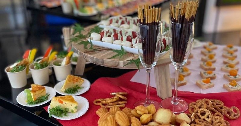 A table topped with plates of food and glasses of wine.