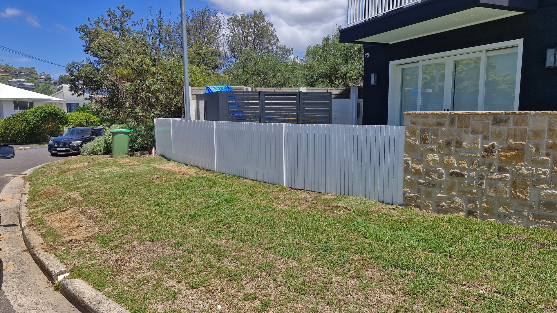 A House With White Fence and Green Grass — Strike Fencing & Gates In Tuggerah, NSW