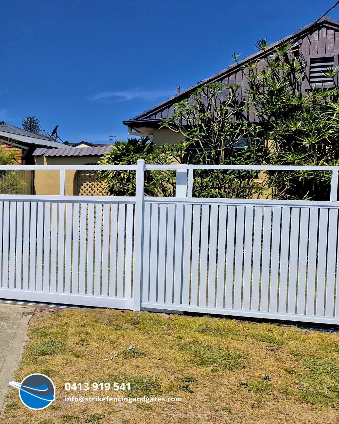 White Picket Fence in Front of a House, Bright Blue Sky, and Green Grass — Strike Fencing & Gates In Bateau Bay, NSW