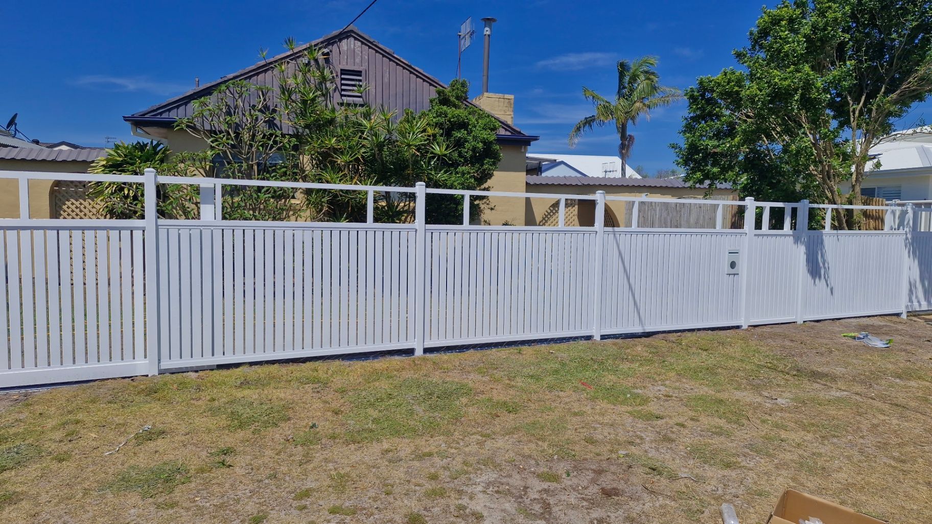 White Picket Fence in Front of a House, Sunny Day, Blue Sky — Strike Fencing & Gates In Tuggerah, NSW