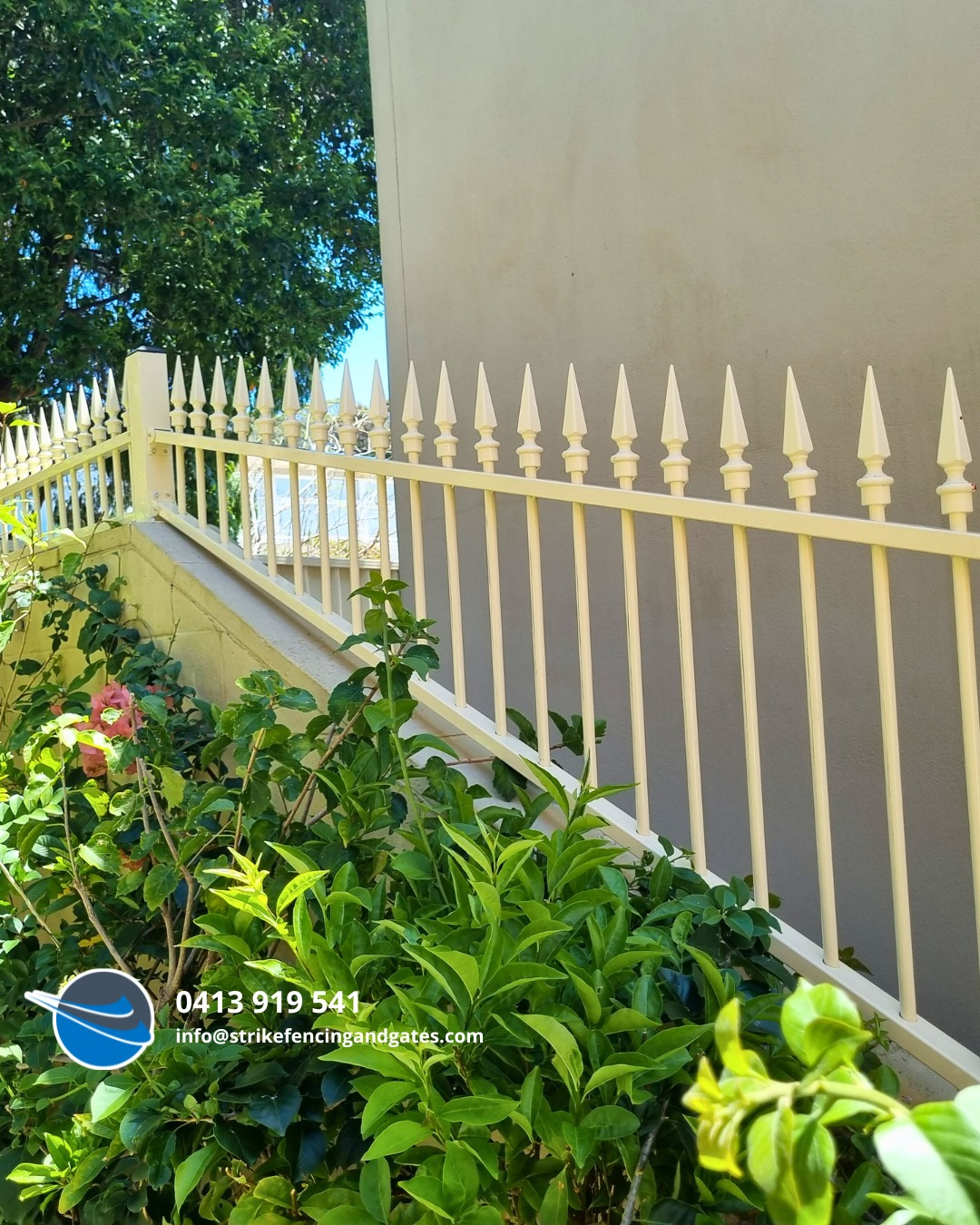 Spiked Fence Along a Beige Wall — Strike Fencing & Gates In Wamberal, NSW