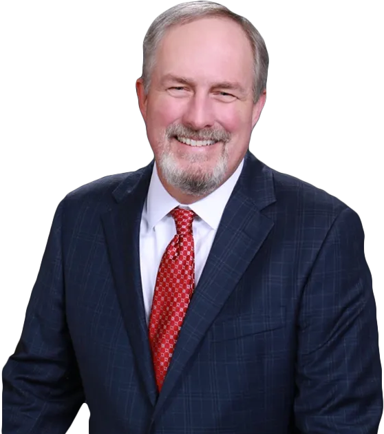 A man in a suit and tie is smiling for the camera