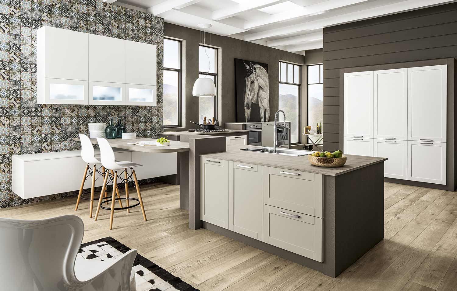 una cucina con mobili bianchi e una grande isola al centro.