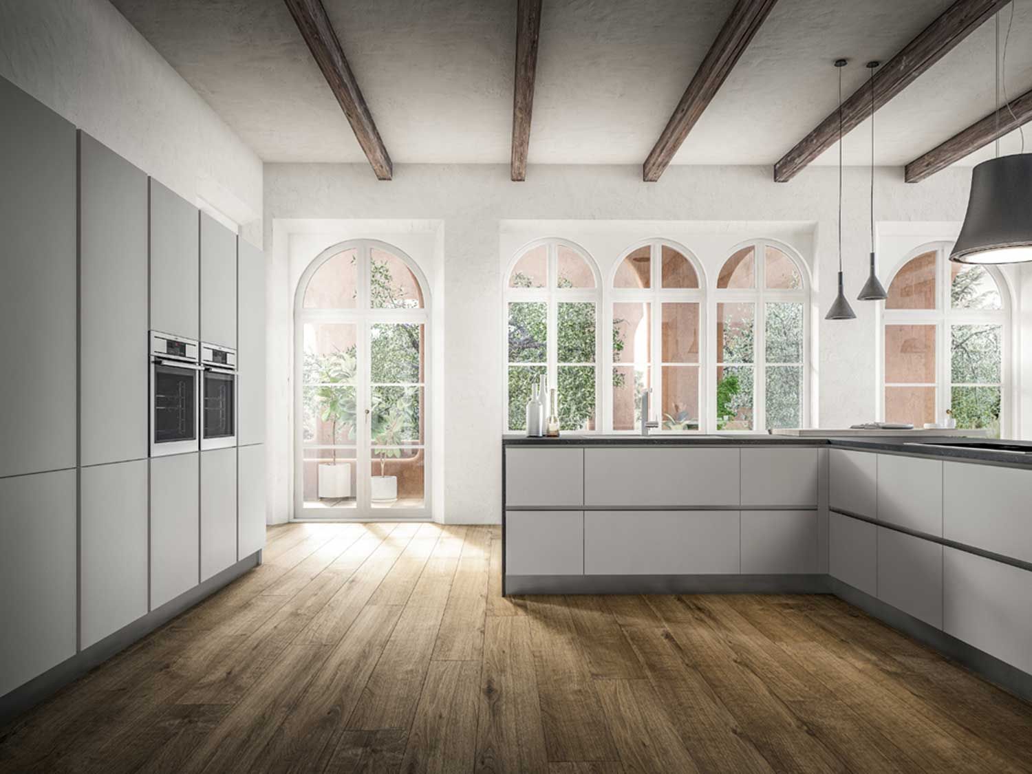 cucina con mobili bianchi e pavimenti in legno e una grande isola al centro