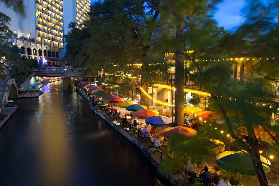 A river with a lot of umbrellas on the side of it