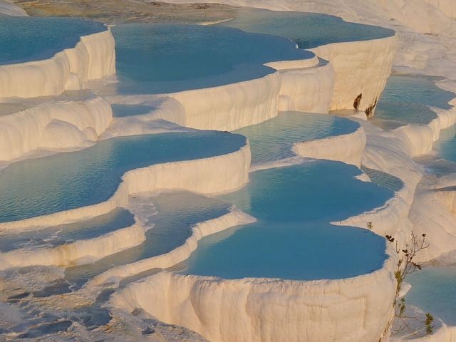 A large body of water is surrounded by white rocks