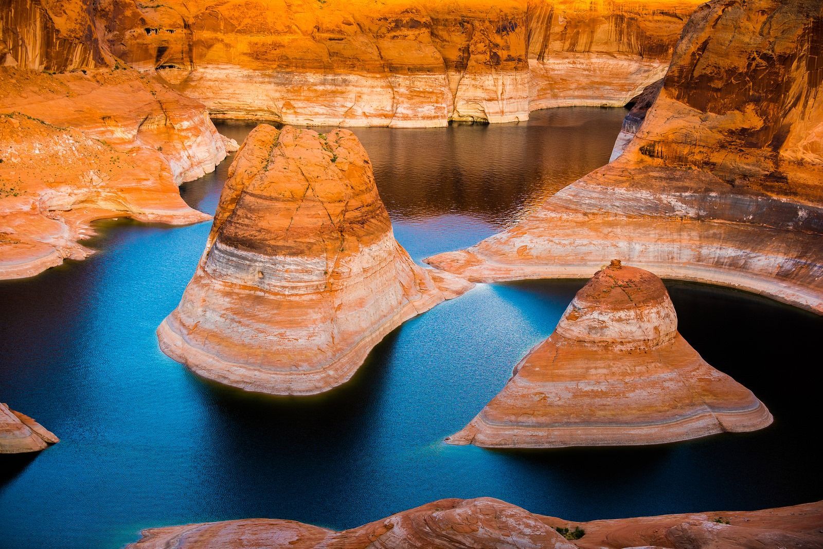 A large body of water surrounded by rocks and cliffs.