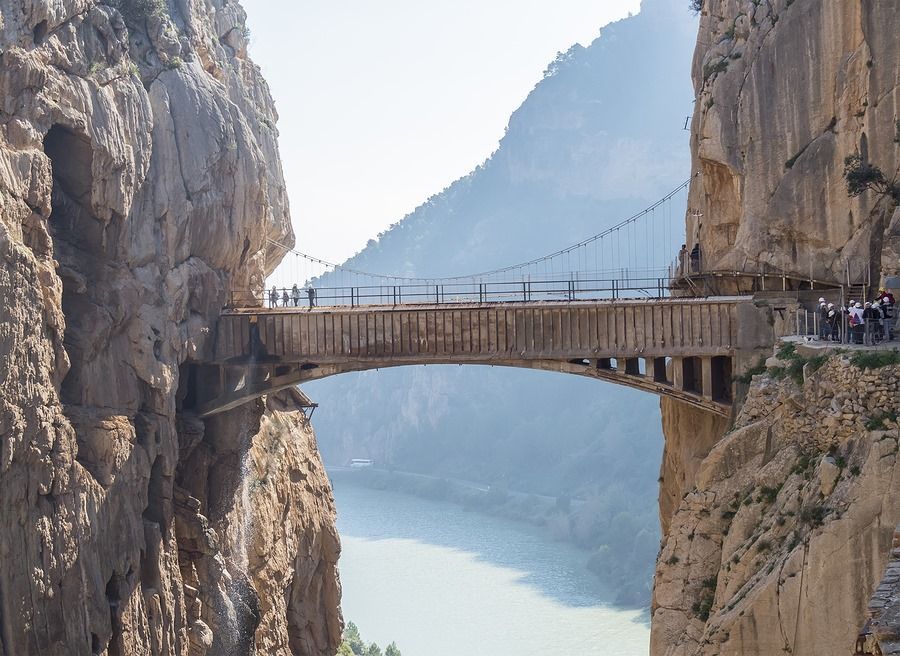 A bridge over a river between two mountains.