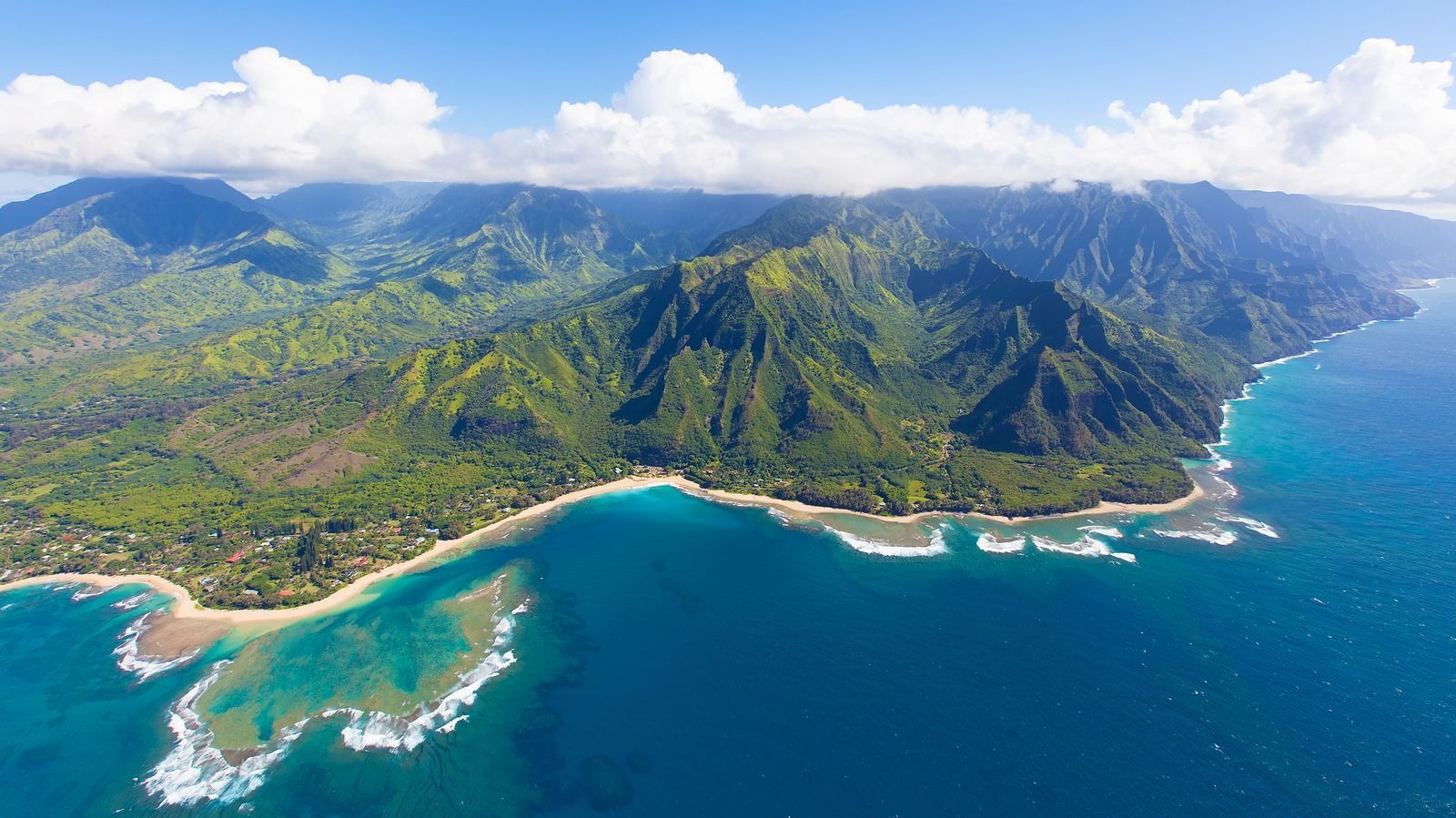 An aerial view of a large body of water surrounded by mountains.