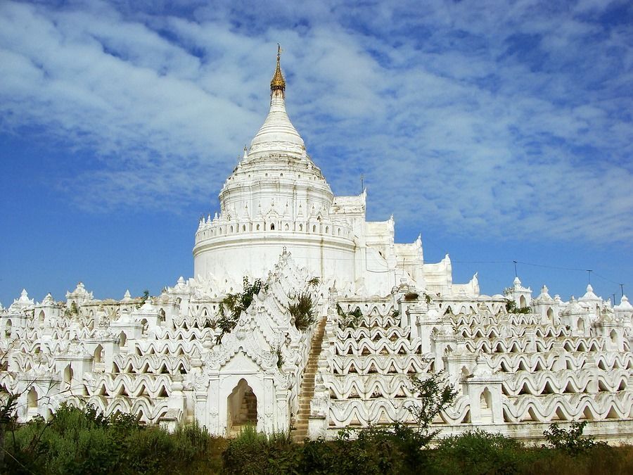 A large white building with a blue sky in the background