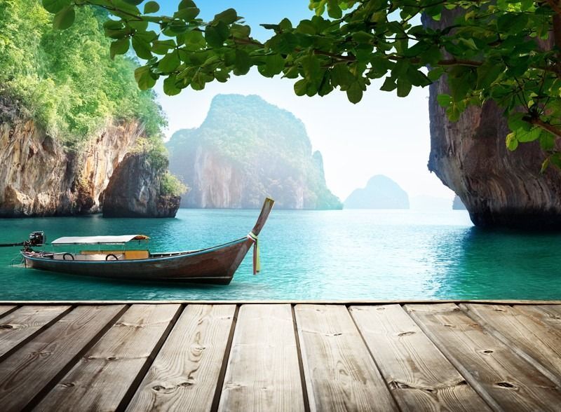 A boat is sitting on a wooden dock in the ocean