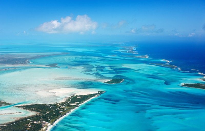 An aerial view of a tropical island in the middle of the ocean.