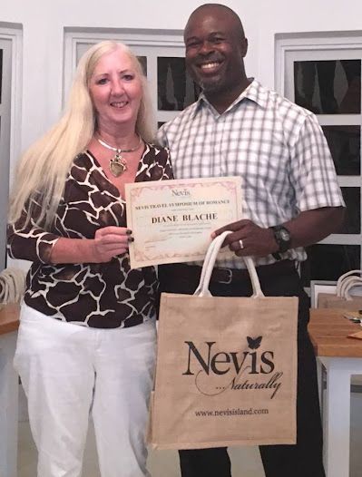 A man and woman holding a bag that says nevis