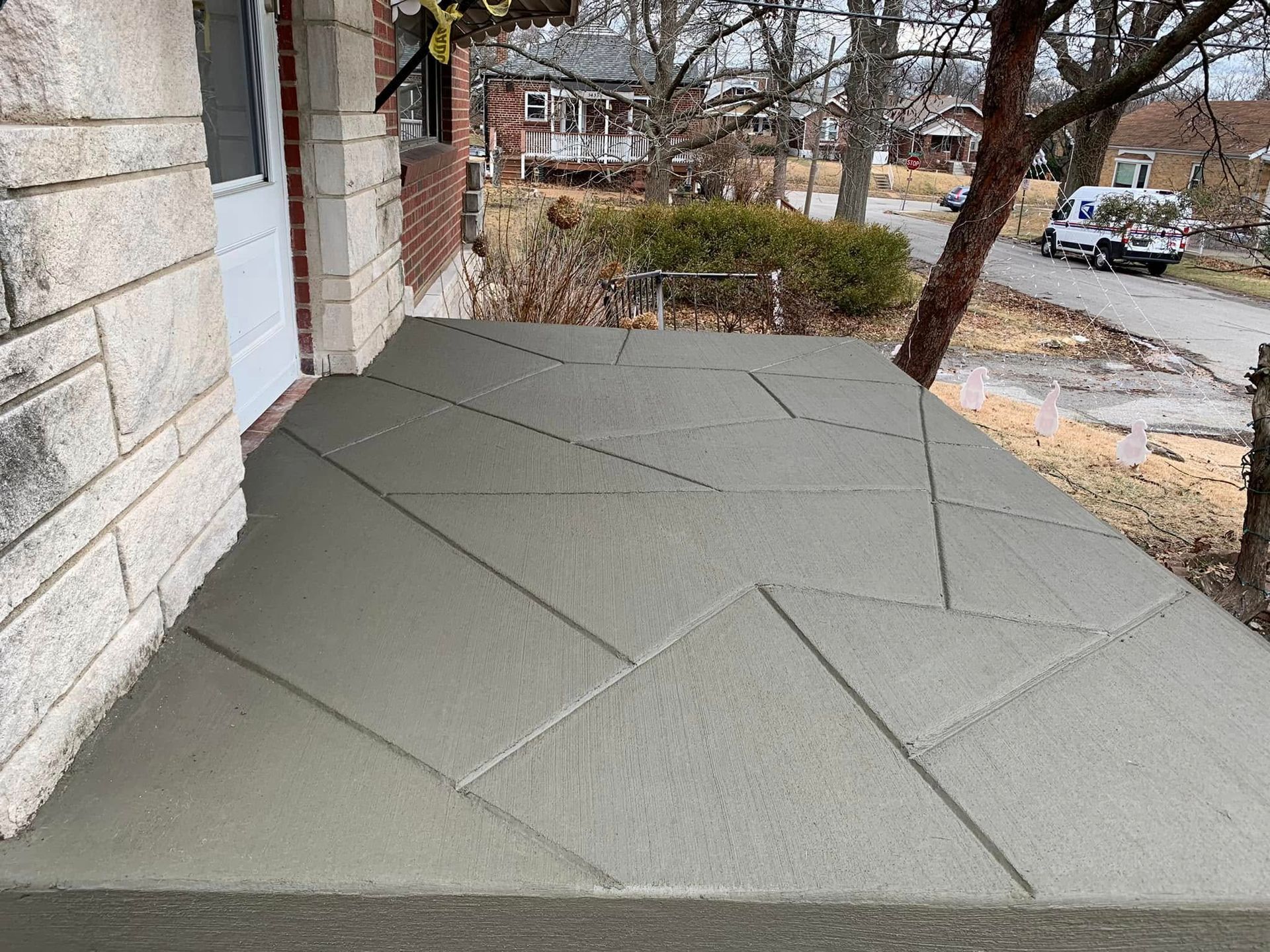 A concrete porch is being built on the side of a house.