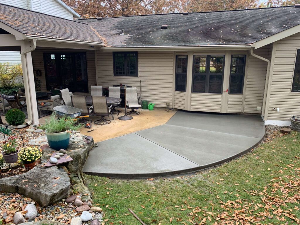 A house with a concrete patio in front of it.