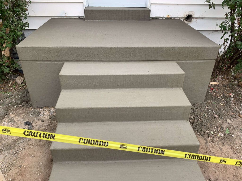 A concrete staircase with a yellow caution tape around it