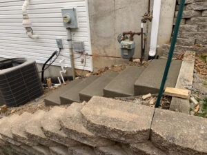 A concrete stairs leading up to a house.
