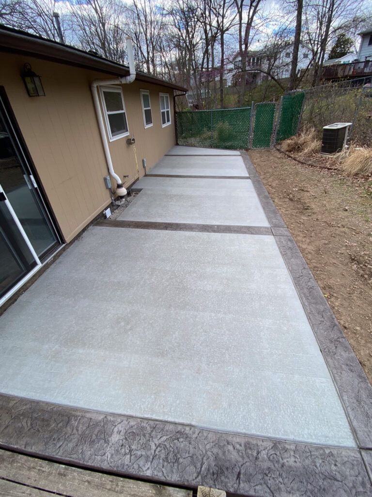 There is a concrete patio in front of a house.