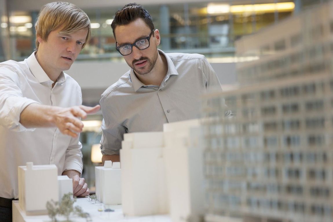 Architects looking at model