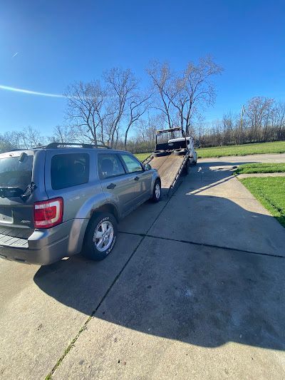 A car is being towed by a tow truck.