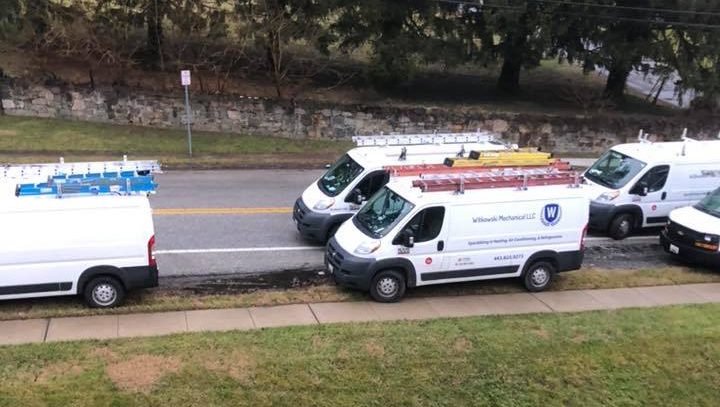 Man Adjusting Thermostat — Cockeysville, MD — Witkowski Mechanical