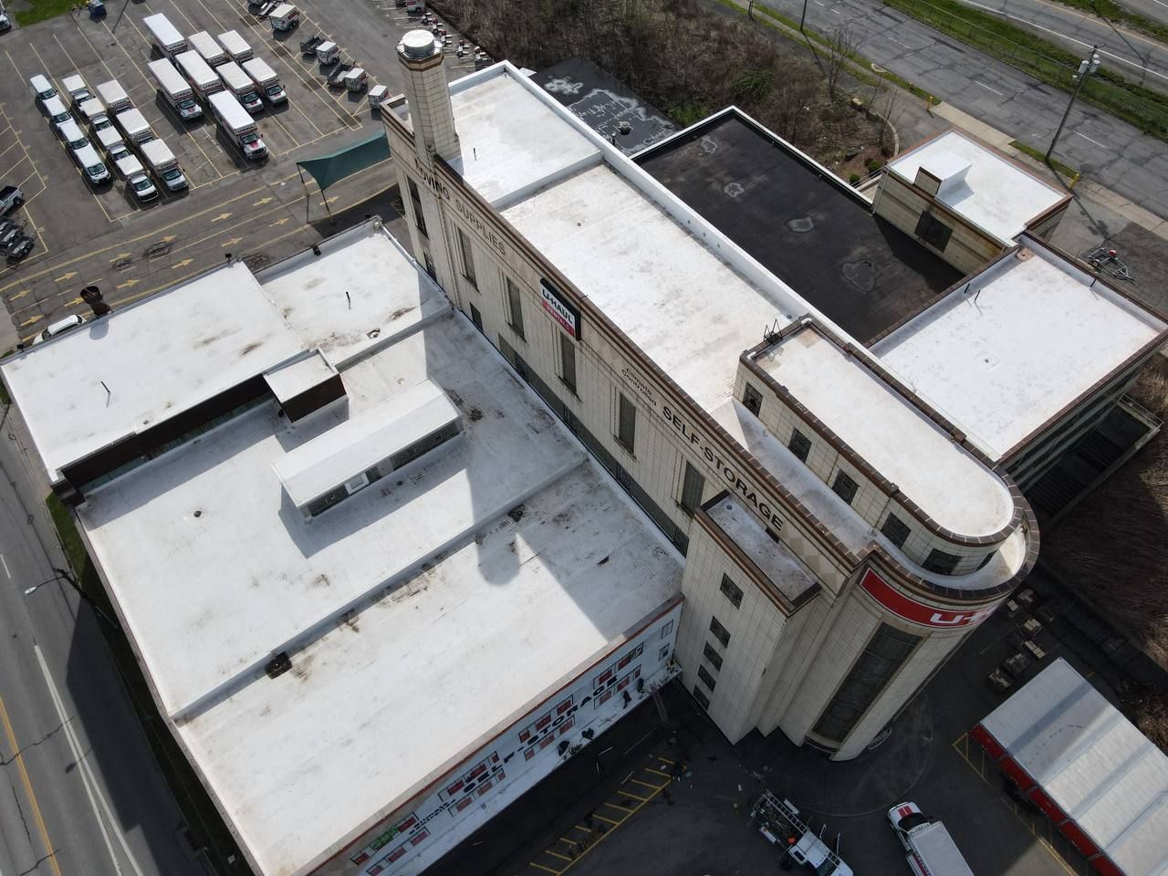 An aerial view of a large building with a white roof
