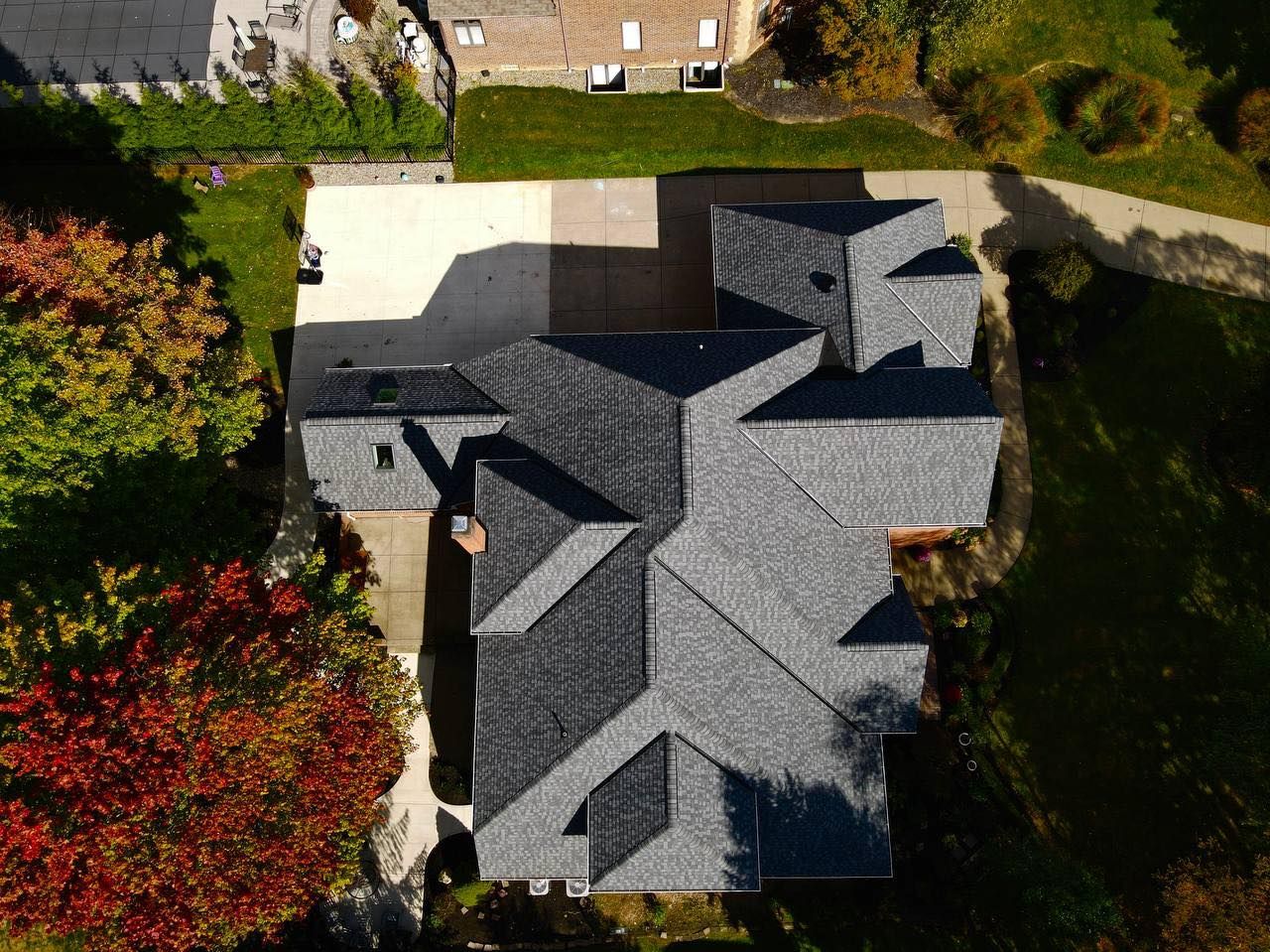An aerial view of a house with a gray roof