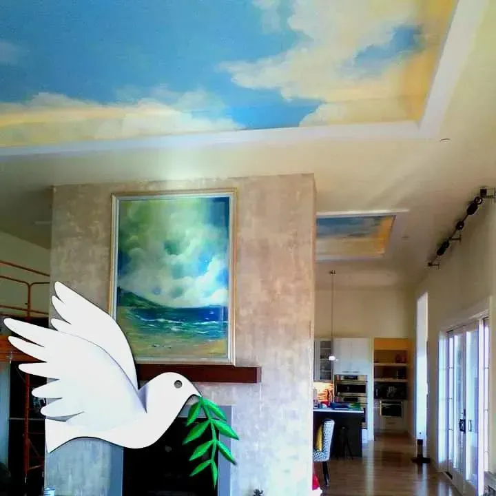 White dove holding a green olive branch in front of a fireplace, with a ceiling painted with clouds.