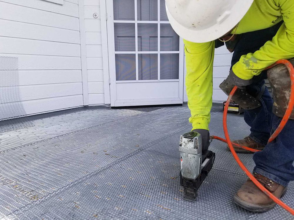 EmpireWorks Team Member Performing Deck and Balcony Repairs