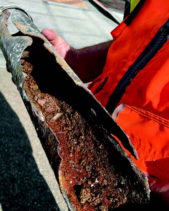 EmpireWorks Team Member Holding Rusted Pipe