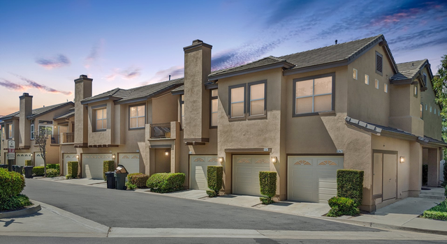 a row of houses with garages in a residential area.