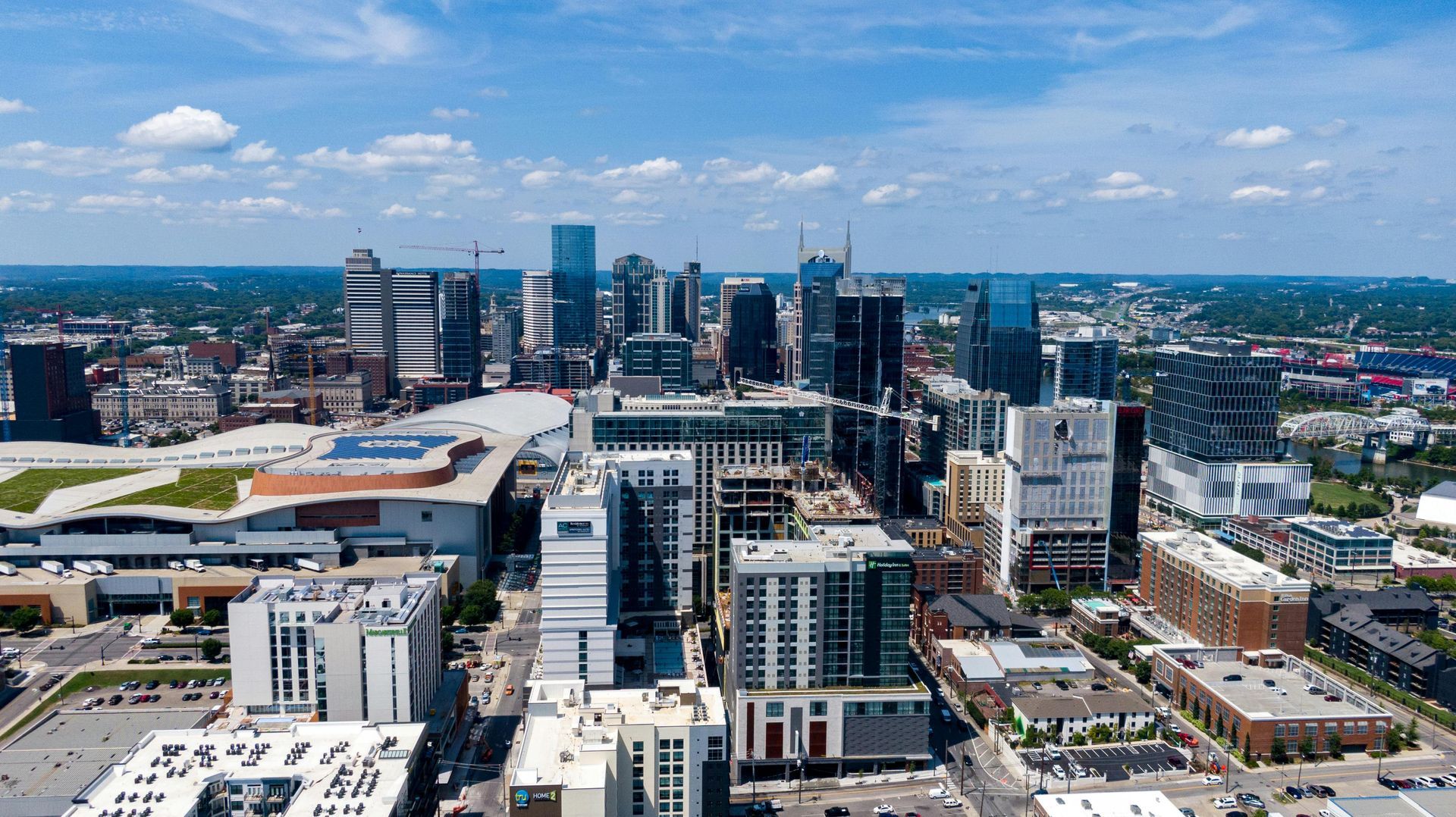 An aerial view of a city with a lot of buildings and a blue sky.