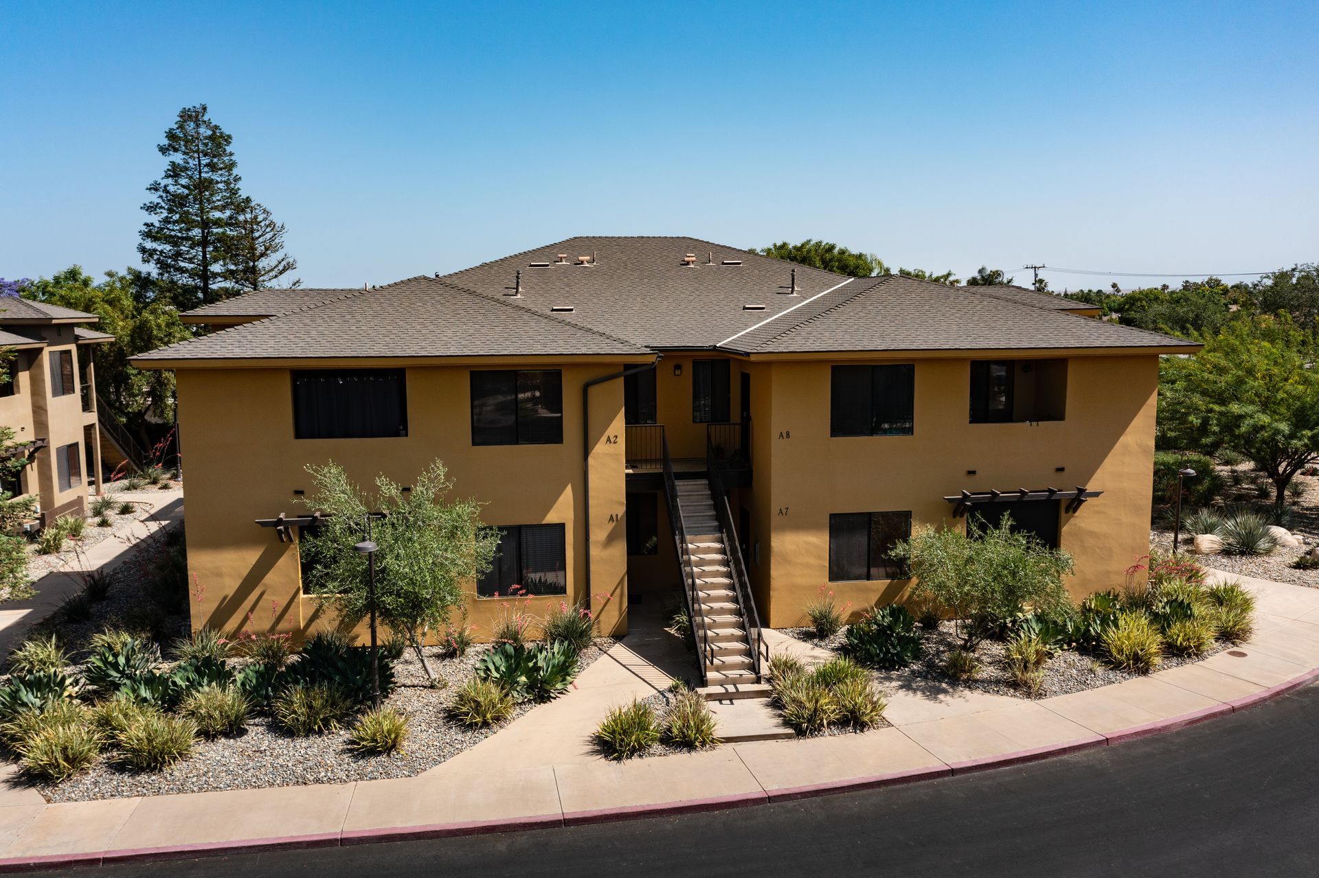 An aerial view of a large apartment building with stairs leading up to it